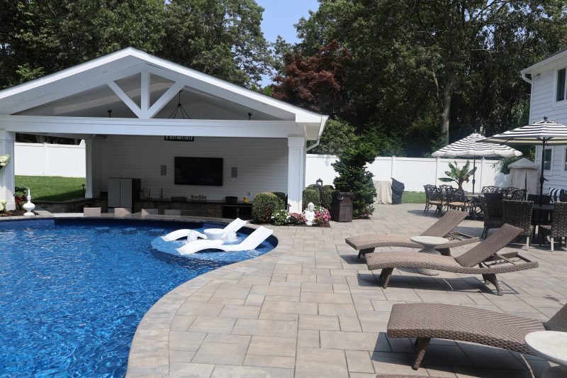 Stone pool surround and coping at a Long Island pool