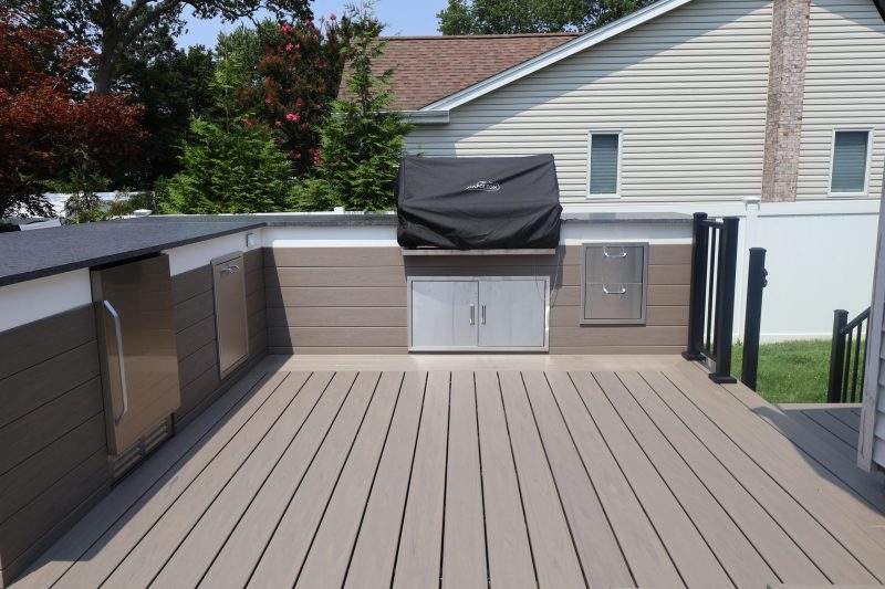 Built-in grill and stone outdoor kitchen on a Long Island patio