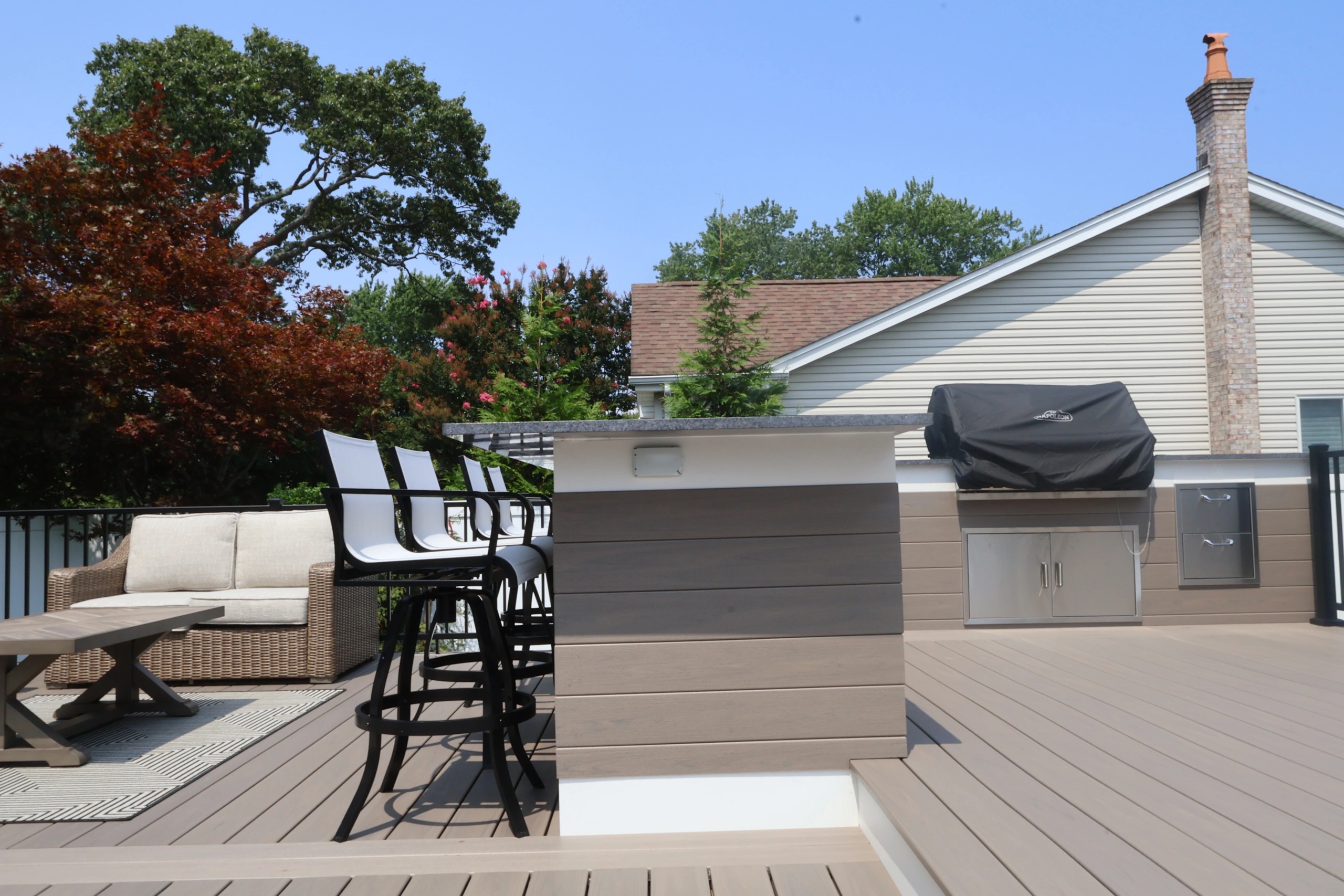 Bar-height seating and grill station on a covered outdoor terrace