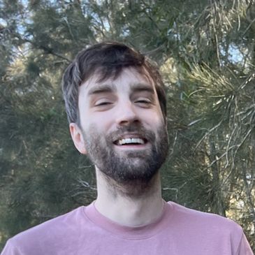Dr Thomas Brown from Cannabis Doctors Tasmania standing in front of a green bush