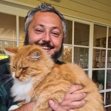 Dr Tom Kaczor holding a cat from Cannabis Doctors Tasmania
