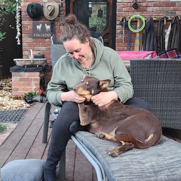 Practice manager Emily patting dog