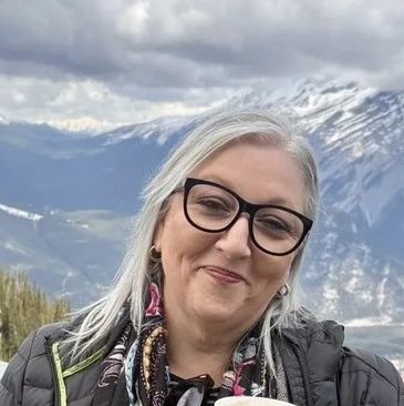 Maria from the Cannabis Doctors Tasmania reception team with a mountain in the background