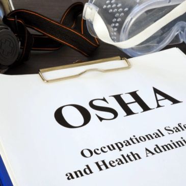 OSHA safety goggles and papers on a table.