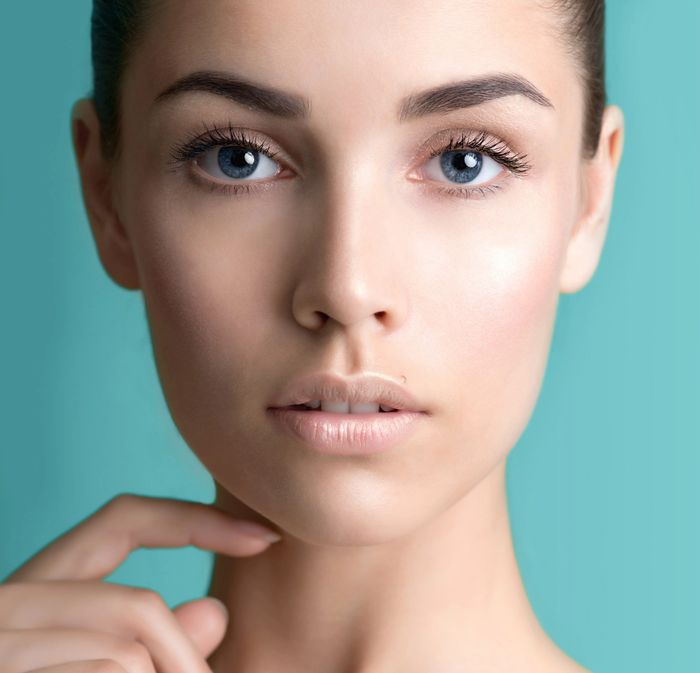 A close-up of a person’s face with a smooth and fair skin