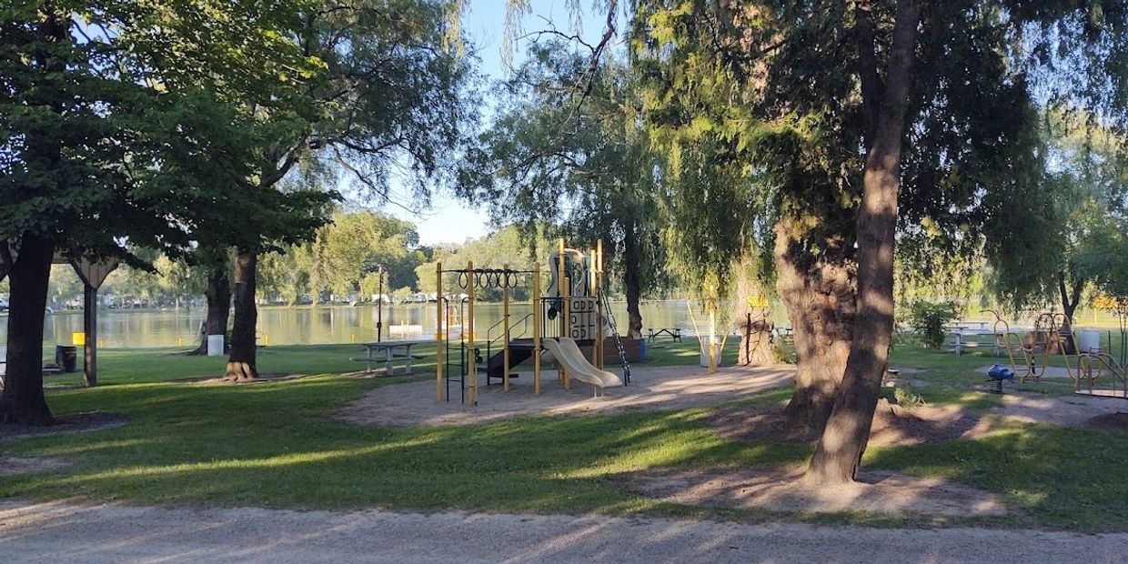 kids full size playground on the beach at Lake Lenwood with the private lake in the background.