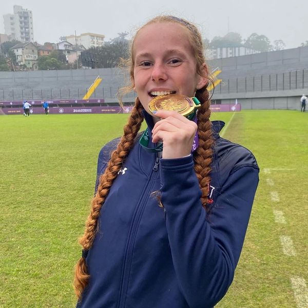 Goalkeeper biting gold medal after victory with the deaf national team