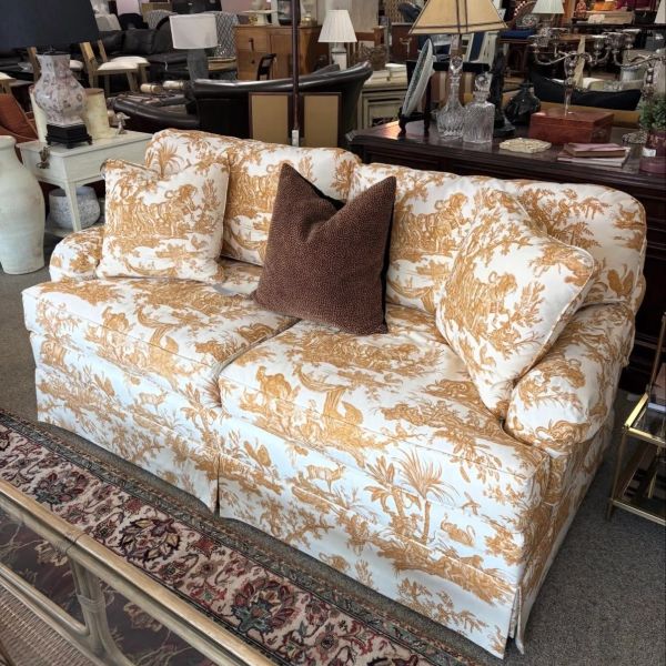 Classic patterned sofa with decorative pillows.