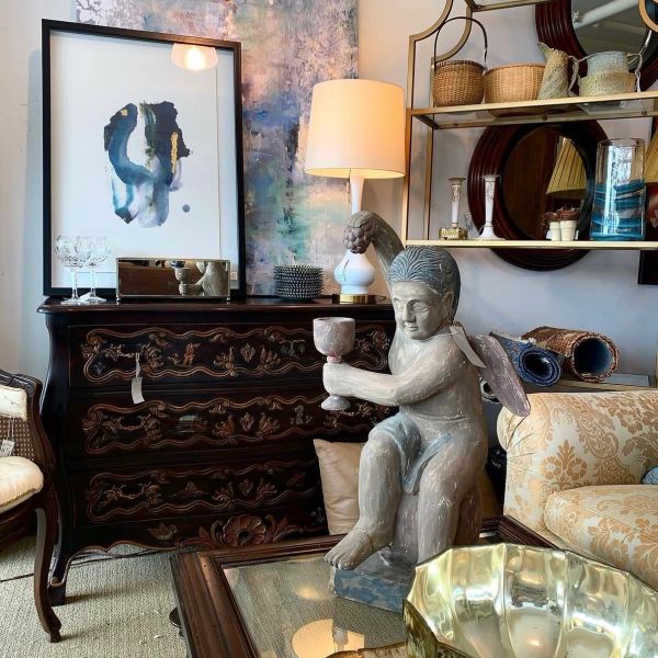 Decorative room with angel statue and vintage furniture.