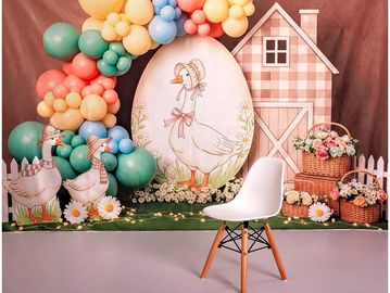 Spring-themed party setup with duck illustrations and pastel balloons.