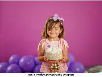 Little girl celebrating her 4th birthday with a cake.