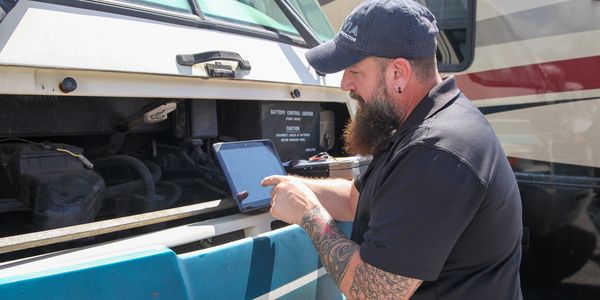 RV Inspector using a tablet for a RV Inspection to inspect a RV, Motorhome.