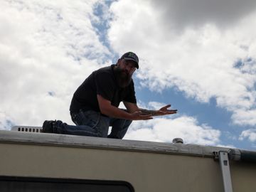 RV Inspector doing a roof inspection on a motorhome