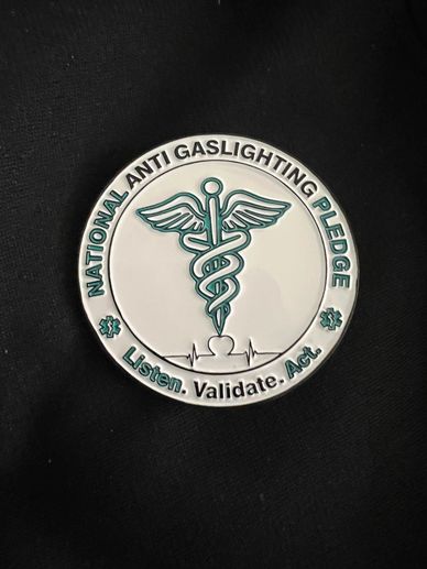 A pin promoting the National Anti Gaslighting Pledge with medical symbol and heartbeat line.