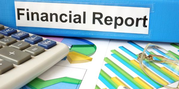 A financial report folder with charts, calculator, and glasses.