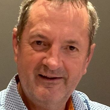 Portrait of a middle-aged man with a slight smile.
