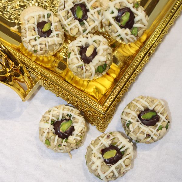 Decorative sweets with pistachio on golden tray.