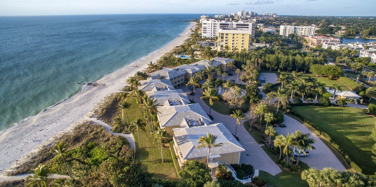 Aerial view of beachfront buildings and greenery in Southwest Florida