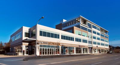 Modern commercial building with clear blue sky above.