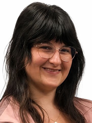 Young woman with glasses smiling.