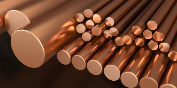 Close-up of polished copper rods arranged by size.
