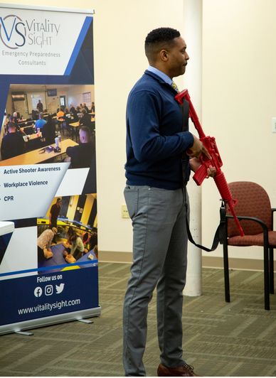 a man holding a gun for Corporate Training