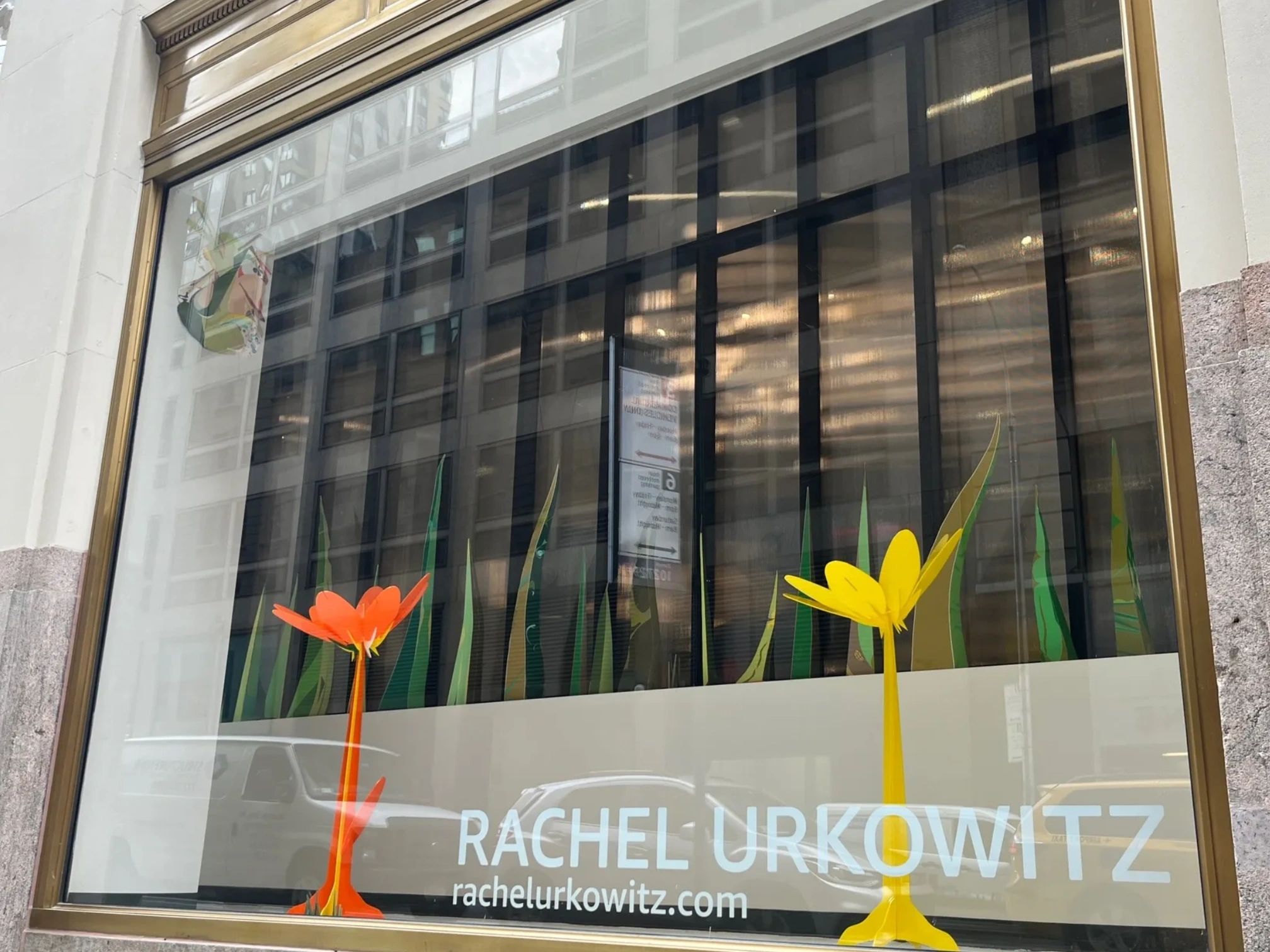 View from the street of Large acrylic flowers and paper blades of grass.
Amazon Headquarters front w