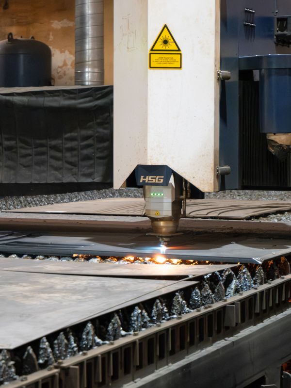 A CNC machine cutting metal sheets in an industrial workshop.