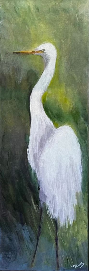 Elegant white egret with long neck against a green background.