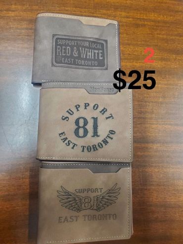 Three brown wallets on a wooden surface priced at $25.
