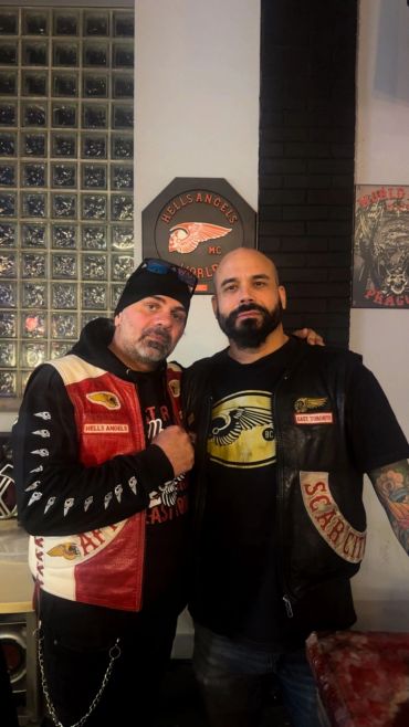 Two men posing wearing Hells Angels jackets.