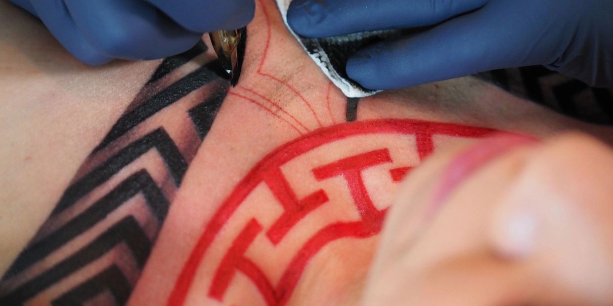 Halifax Nova Scotia Tattoo Artist tattoos female cleints chest with bold tribal tattoos