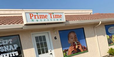 Exterior of Prime Time Nutrition with a large image of a child drinking juice.