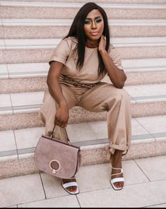 London-based influencer Mosope in nude shirt trouser ensemble, sandal stilettoes, nude leather bag
