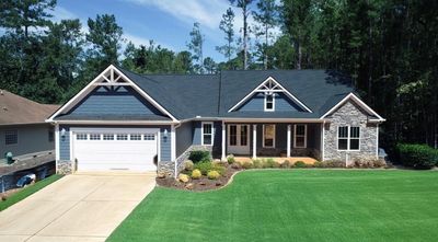 Modern suburban house with a two-car garage and landscaped front yard.