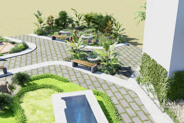 Modern garden with benches, plants, and a water feature in a paved area.