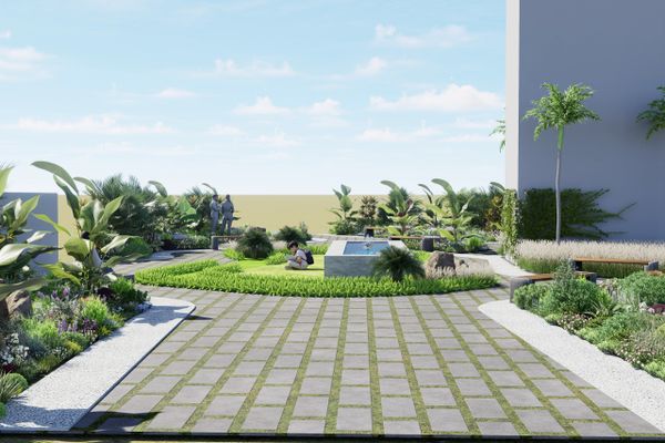 Modern garden with paved walkway, lush greenery, and seating area under clear sky.
