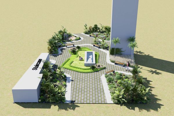 Modern outdoor park with pathways, greenery, and a central monument.