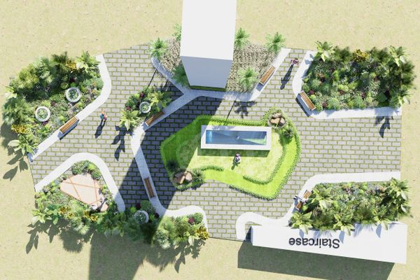 Top view of a landscaped park area with pathways, benches, and greenery.