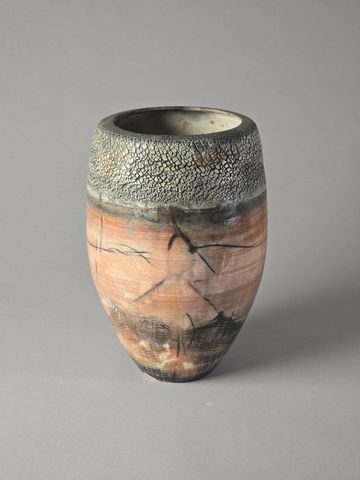Handcrafted ceramic vase with textured upper rim and earthy tones.