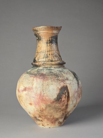 Ancient pottery vase with a cracked, multicolored glaze and a narrow neck.