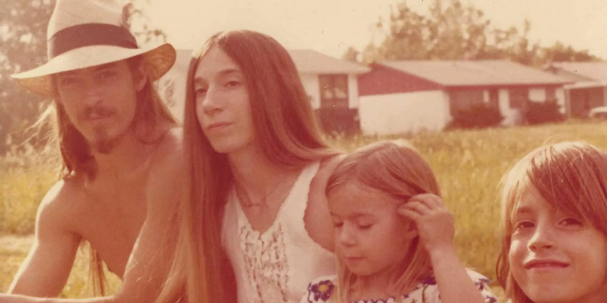 A vintage photo of a family relaxing outdoors on a sunny day.