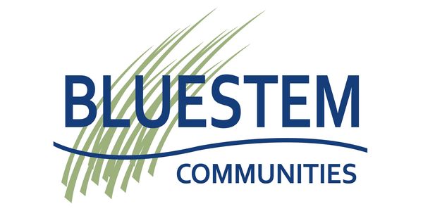 Bluestem Communities logo with green grass and blue text.