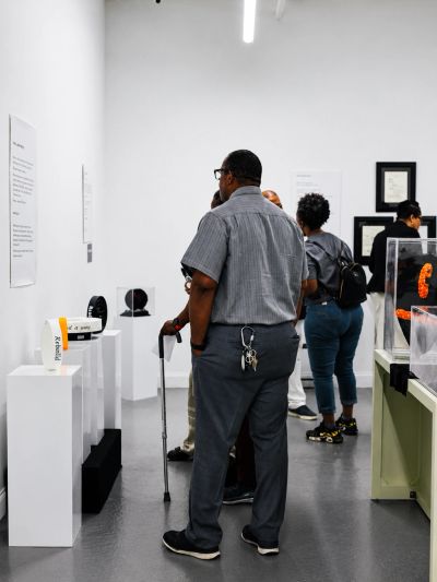 People observing art in a gallery.