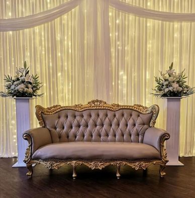 Chesterfield style bridal sofa with gold ornate edging.