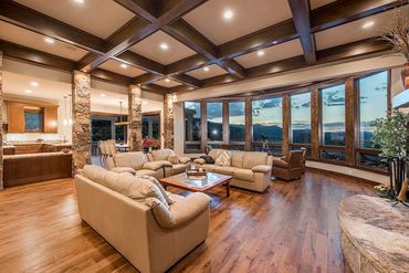 modern living room with lots of windows and rock fireplace