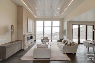 modern white living room with stone fireplace