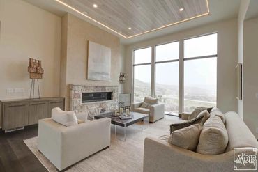 modern white living room with stone fireplace