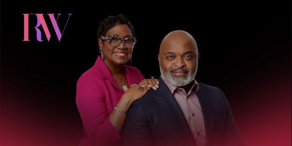 A confident couple posing against a black background with RW logo.