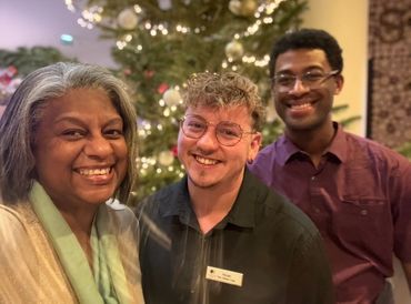 Greer and Donovan with Novan, an employee at the hotel in front of the Christmas tree in the lobby.